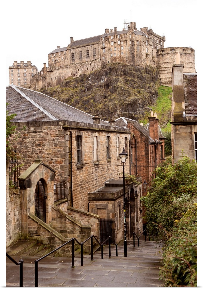 Photograph of Edinburgh Castle with cobblestone buildings in the foreground.