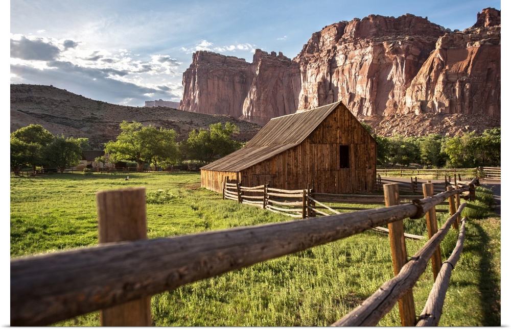 Gifford Homestead with the cliffs of the Waterpocket Fold overlooking it at Capitol Reef National Park in Utah.