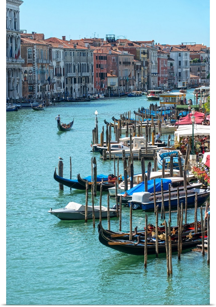 Photograph of docked gondolas and boats on the Grand Canal in Venice.