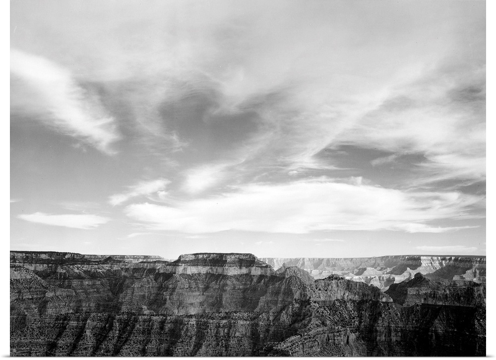 Grand Canyon National Park, canyon edge, low horizon, clouded sky.
