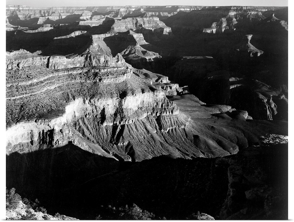 Grand Canyon National Park, panorama, dark shadows in foreground and right framing cliffs at left and center.