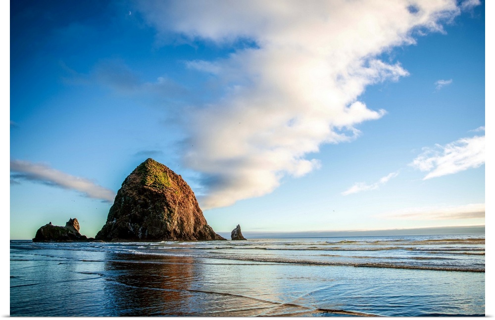 Photograph of Haystack Rock at golden hour just before sunset.