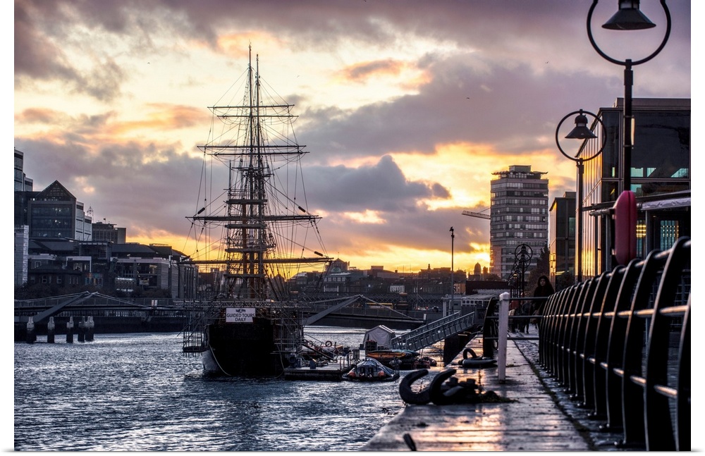 View of Jeanie Johnston tall ship docked in Dublin, Ireland as the sun is setting.