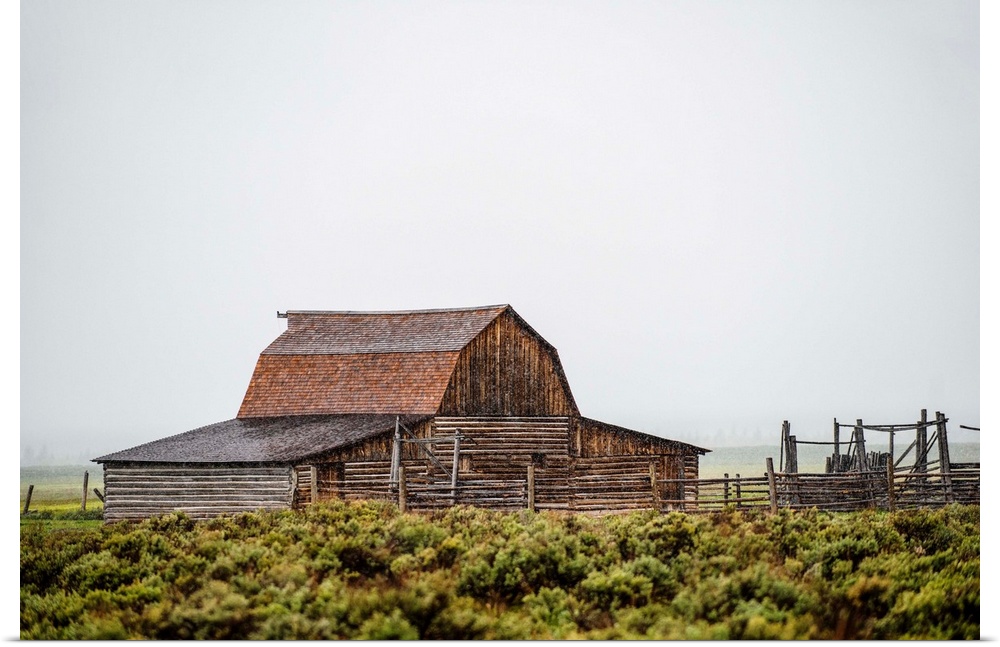 View of the John Moulton Barn with fog rolling in, Grand Teton National Park, Wyoming.