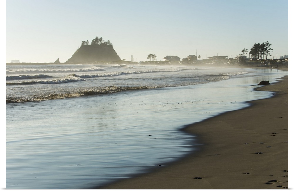 Landscape photograph of the La Push Beach shore with misty rock cliffs in the background.