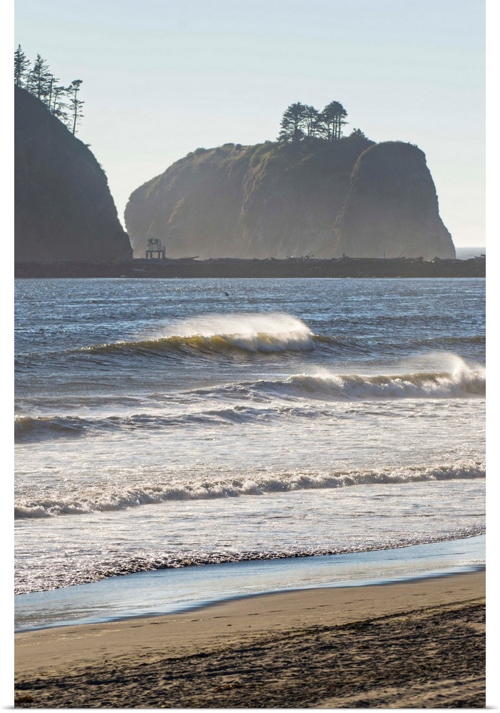 Landscape photograph of waves crashing on the shore in La Push, Washington, with rocky cliffs in the background.