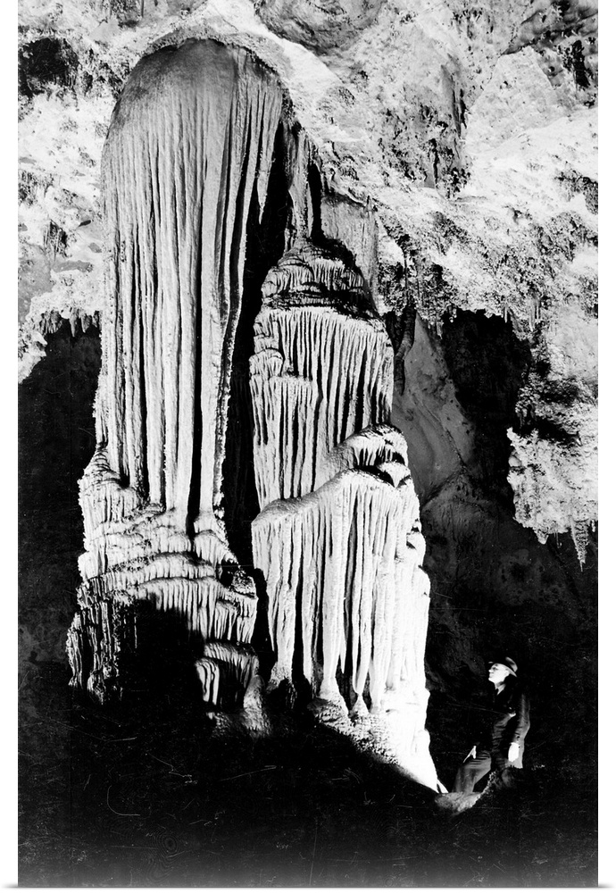 Large Stalactite Formation in the Kings Palace, illuminated stalactite, man on right.