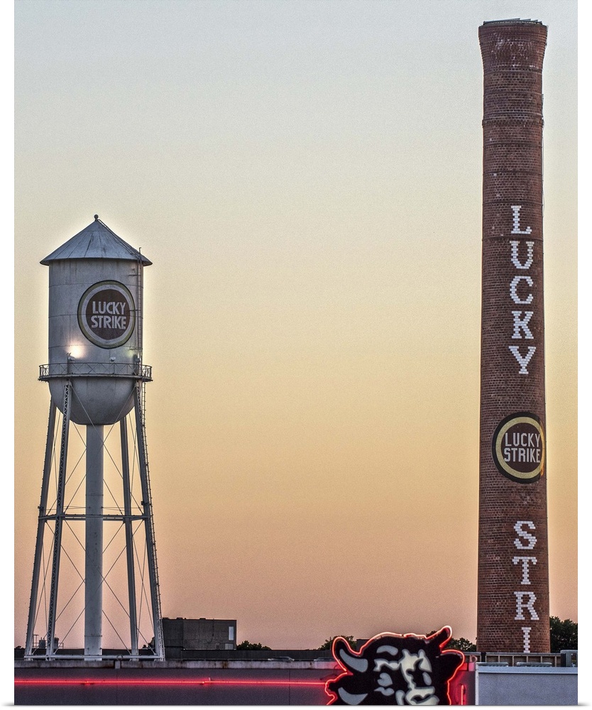 Lucky Strike Water Tower and Smokestack at sunset, over the neon Bull sign, American Tobacco Historic District, Durham, No...