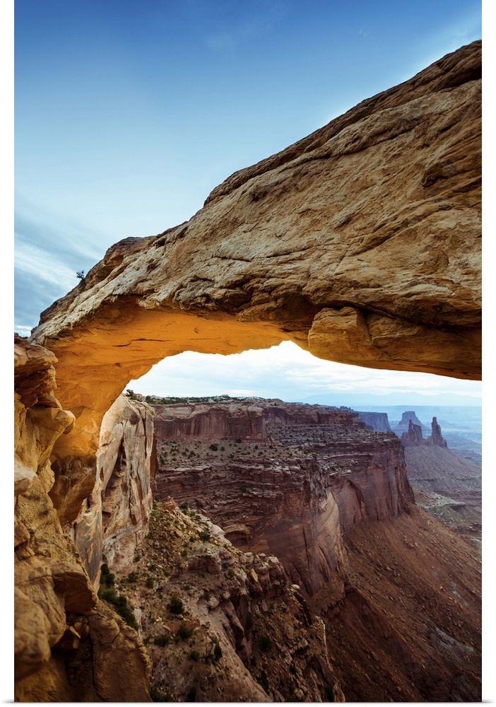 Photograph of the Mesa Arch with canyons in the background in Arches National Park, Utah.