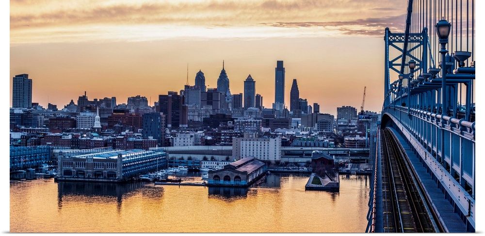 View of Philadelphia's city skyline against a dewy melon colored sky.