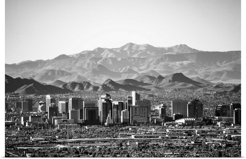 Photograph of the Phoenix, Arizona skyline with hazy desert mountains in the background.