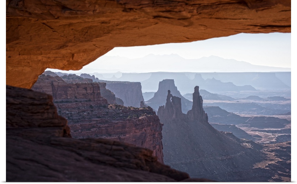View of the desert landscape of Buck Canyon from under the Mesa Arch, Canyonlands National Park, Moab, Utah.