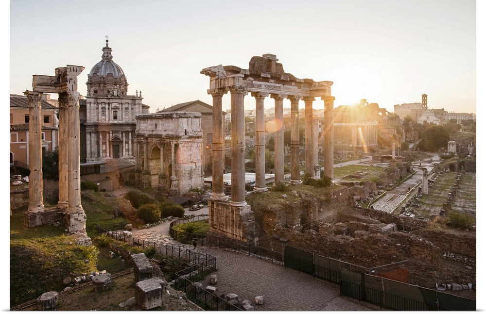 Photograph of the ruins at the Roman Forum with the sun shining in the background.