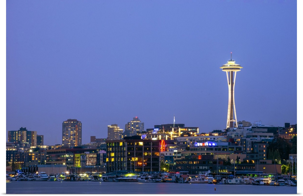 Photograph of the Seattle skyline lit up at night from the water.