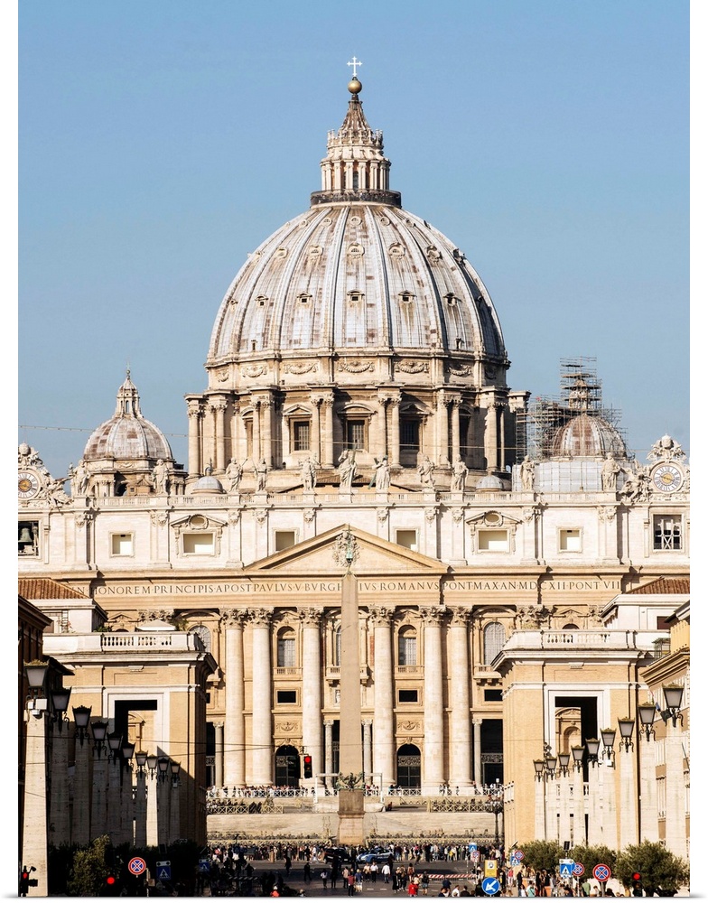Photograph of St. Peter's Basilica in Vatican City with the sun shining on it.