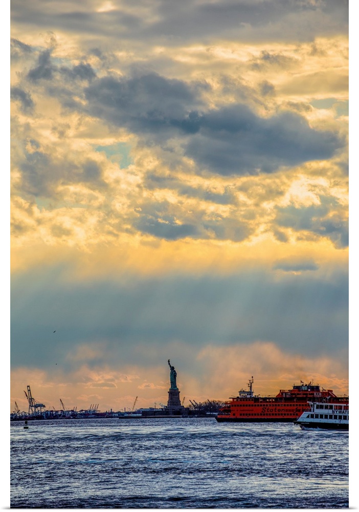 View of the Statue of Liberty with dramatic clouds overhead.
