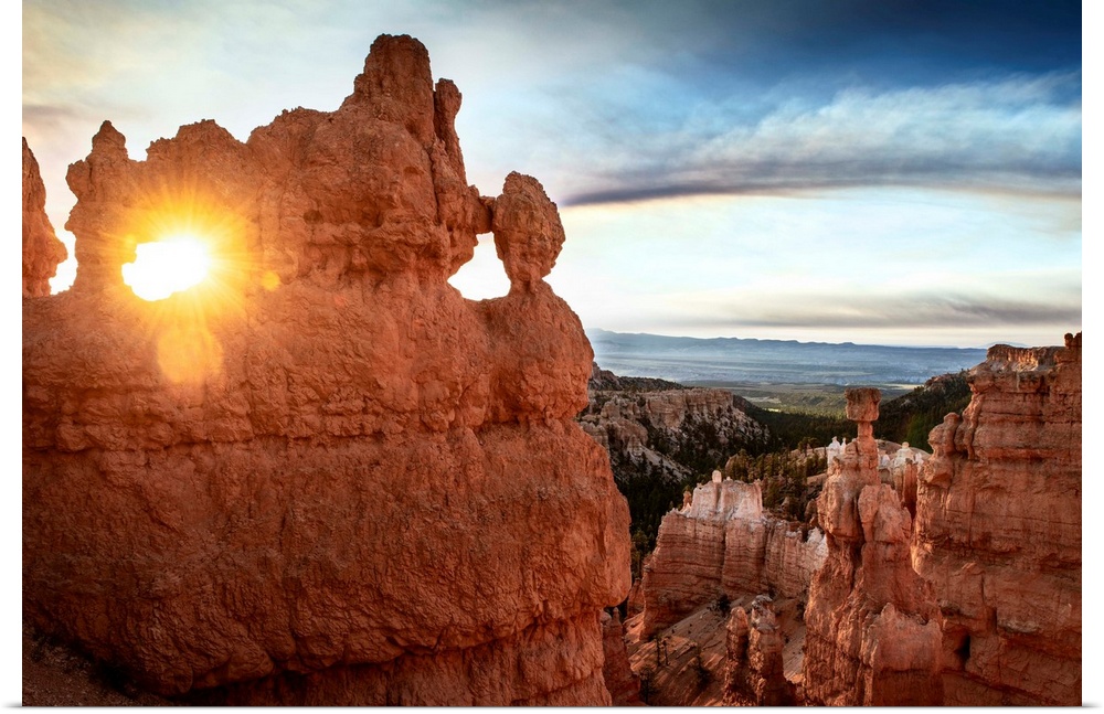 The sun shining through a naturally eroded hole in a hoodoo formation in Bryce Canyon National Park, Utah.