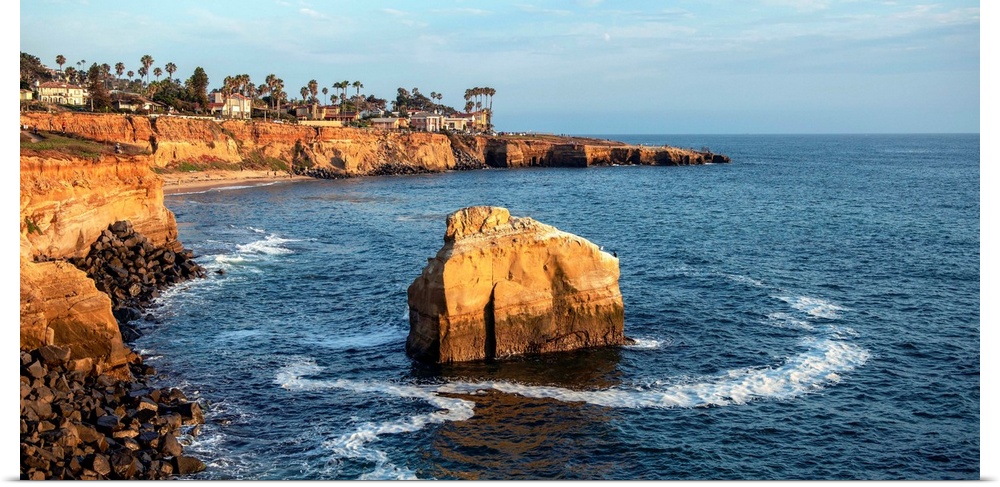 The sun sets on a lone boulder in San Diego. The Sunset Cliffs are known for their picturesque landscape.