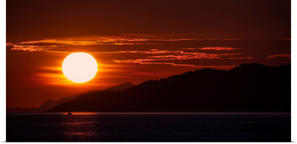 The sun sets on Burrard Inlet near Vancouver in British Columbia, Canada.
