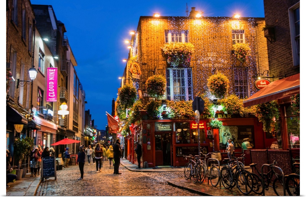 Photograph of Temple Bar, a busy riverside neighborhood in Dublin, Ireland, at night.