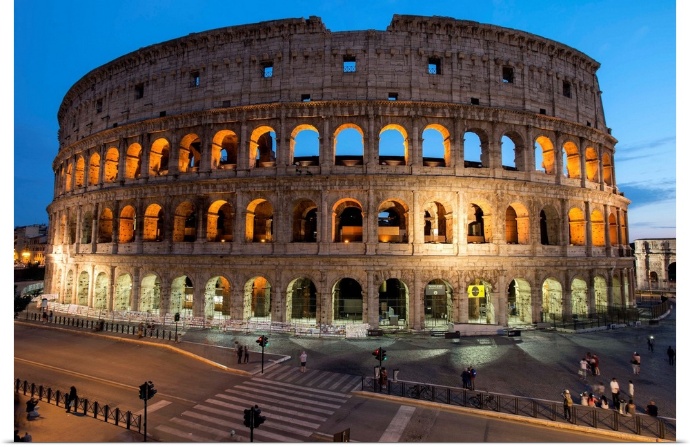 Photograph of the Colosseum lit up at dusk.