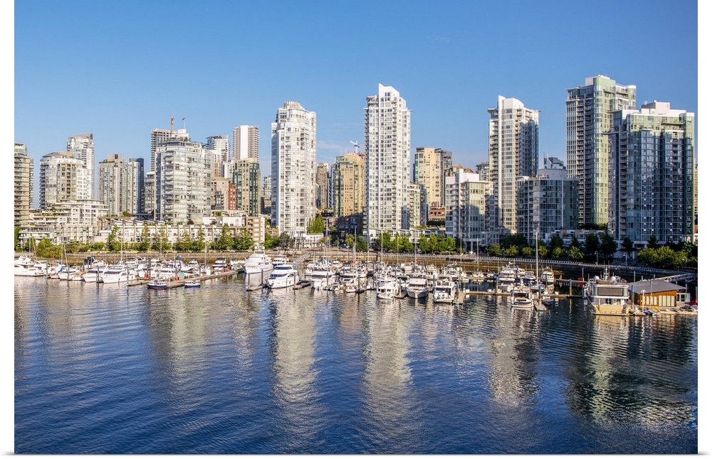 Photograph of part of the Vancouver, British Columbia skyline with False Creek Harbor and boats in the foreground.