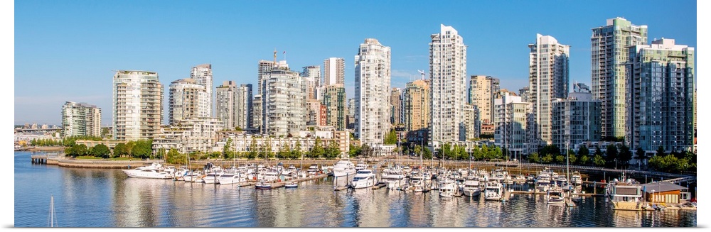 Panoramic photograph of part of the Vancouver, British Columbia skyline with False Creek Harbor and boats in the foreground.