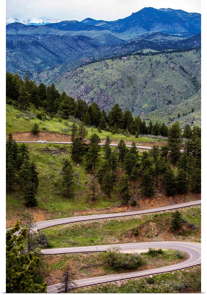 Photo of a winding road below a mountain in Colorado.