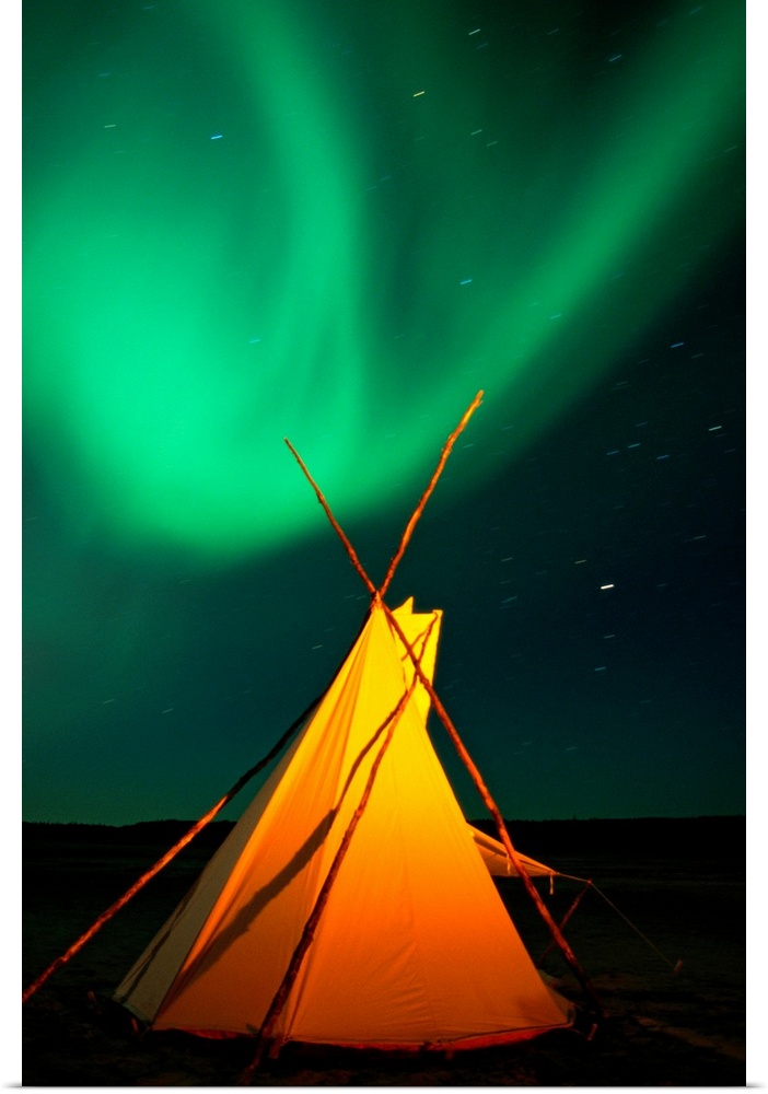 From the National Geographic Collection.  Photograph of tent under neon lights in the night sky.