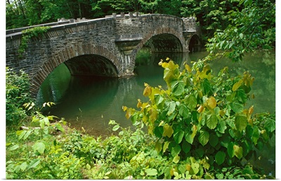 A stone bridge crosses the headwaters of the Susquehanna River, New York