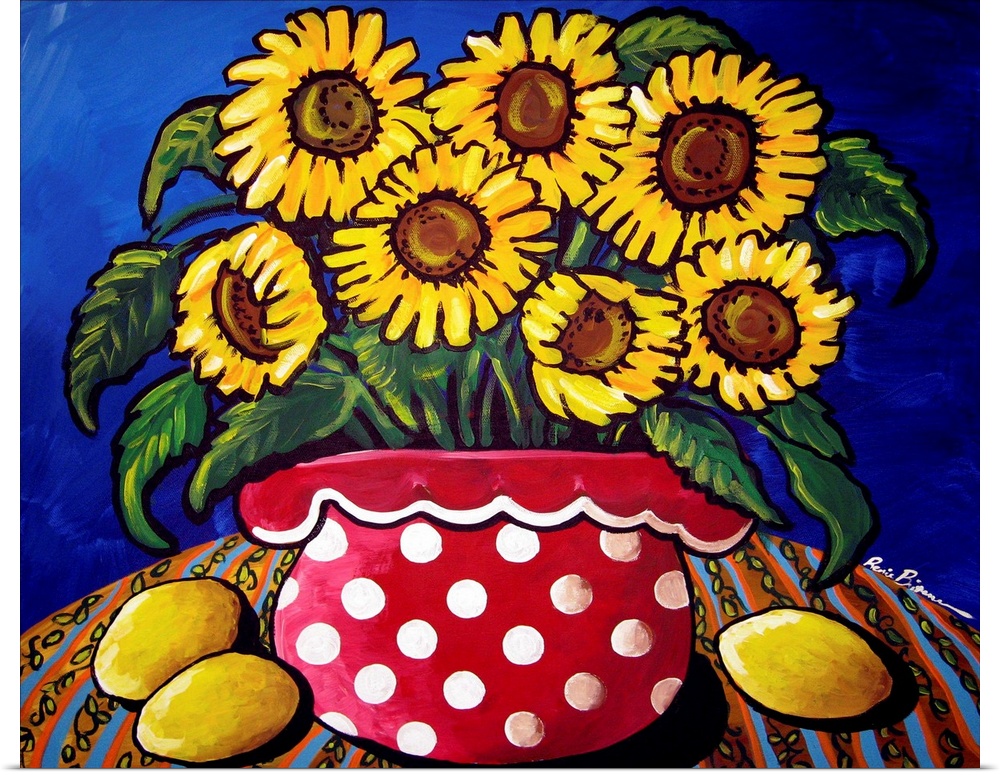 Fun and colorful red polka dotted vase filled with sunflowers. Three lemons sit along side.