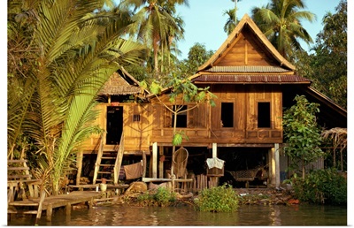 A traditional Thai house on stilts above the river in Bangkok, Thailand