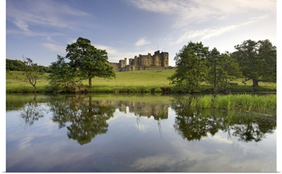 Alnwick Castle reflecting in River Aln, Alnwick, Northumberland, England