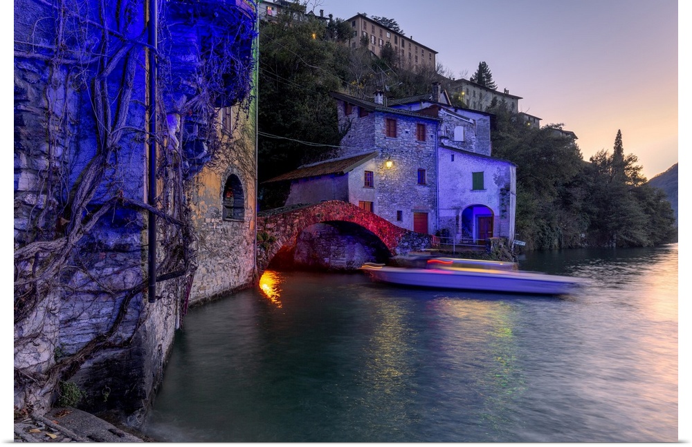 Boat in motion under the illuminated Nesso bridge, Lake Como, Lombardy, Italian Lakes, Italy, Europe