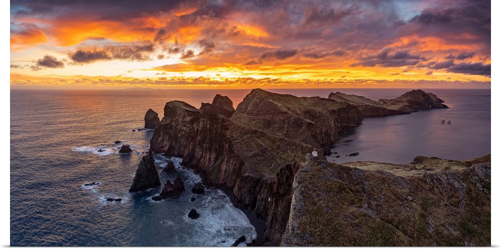 Cliffs by the ocean under the burning sky at dawn, Ponta Do Rosto, Sao Lourenco Peninsula, Madeira island, Portugal, Atlan...