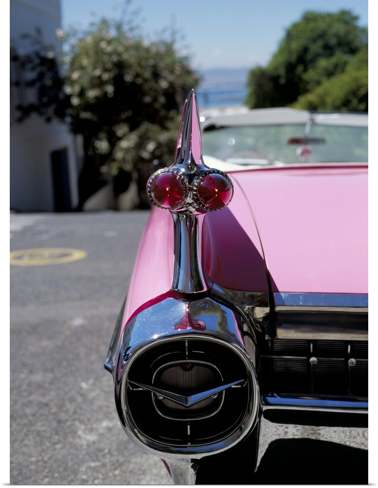 Close-up of fin and lights on a pink Cadillac car