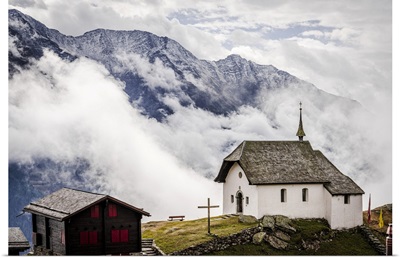 Foggy Sky Over The Small Church In The Alpine Village Of Bettmeralp, Switzerland