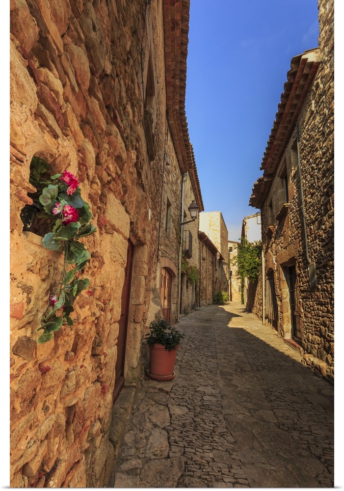 Gorgeous medieval village, cobblestone narrow lane and flowers, Peratallada, Baix Emporda, Girona, Catalonia, Spain, Europe