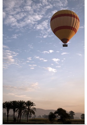 Hot air balloon flying over the Valley of the Kings, Luxor, Egypt