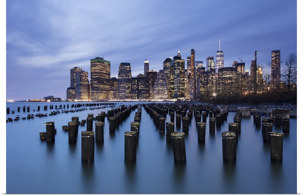 Lower Manhattan skyline with wooden posts from an old pier in the foreground. New York City, New York, United States of Am...