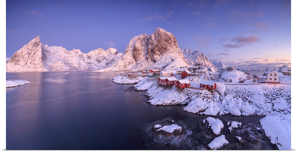 Panoramic view of snowy peaks and frozen sea at dawn around the fishing village, Hamnoy, Nordland, Lofoten Islands, Arctic...