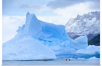 People kayaking near floating icebergs, Patagonian Andes, Chile