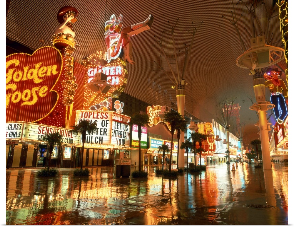 Reflections on wet street of neon signs along Fremont Street in Las Vegas, Nevada