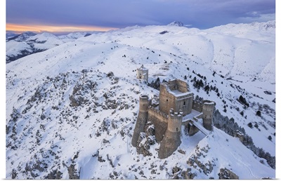 Rocca Calascio Castle And The Santa Maria Della Pieta Church In A Snowy Landscape, Italy
