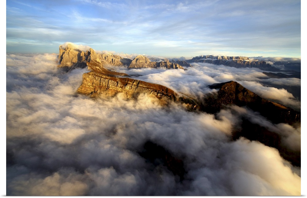 Aerial shot from Seceda of Odle surrounded by clouds at sunset in the Dolomites, Val Funes, Trentino-Alto Adige South Tyro...