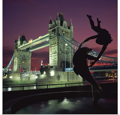 Silhouetted fountain statue and Tower Bridge, London, England, UK