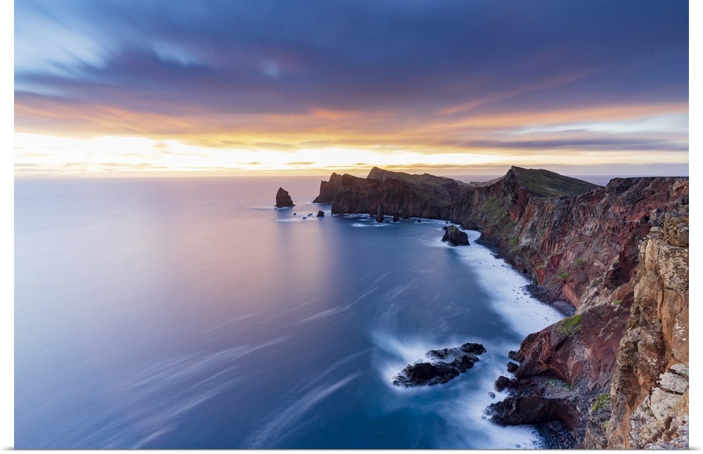 Dramatic sky at dawn on cliffs washed by ocean from Ponta Do Rosto viewpoint, Sao Lourenco Peninsula, Madeira, Portugal, A...