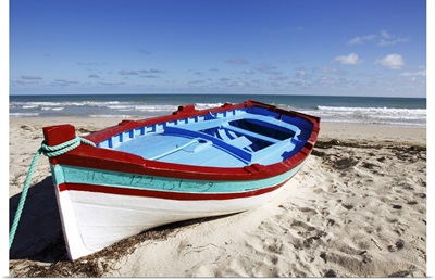 Small  boat on tourist beach the Mediterranean Sea, Djerba Island, Tunisia