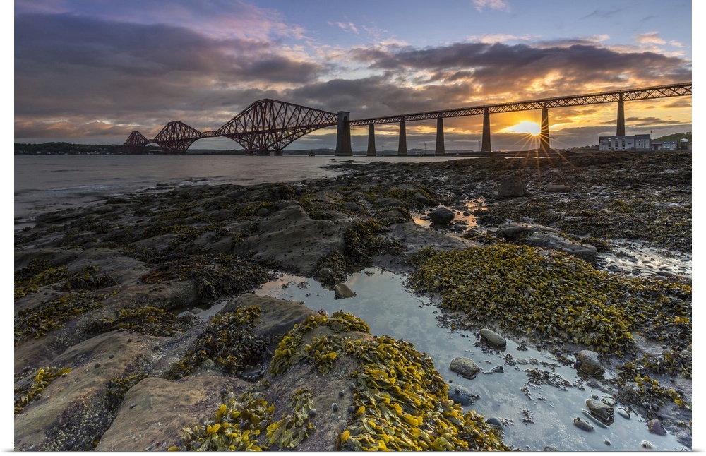 Sunrise through the Forth Rail Bridge, UNESCO World Heritage Site, on the Firth of Forth, South Queensferry, Edinburgh, Lo...