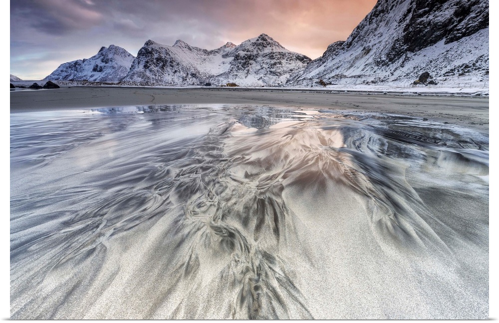 Sunset on the surreal Skagsanden beach surrounded by snow covered mountains, Flakstad, Lofoten Islands, Arctic, Norway, Sc...